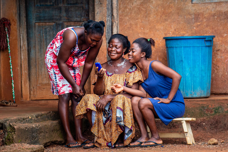 Mother and daughters using phone